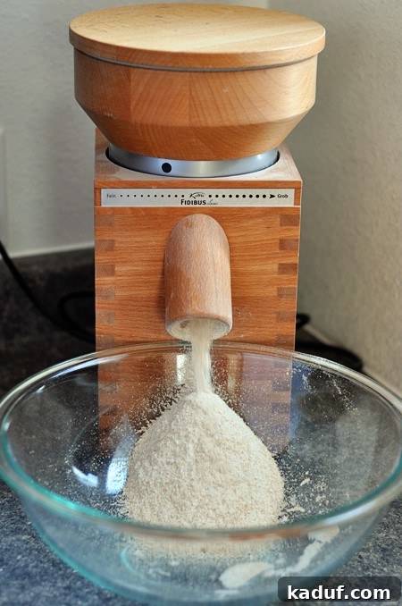 The Ultimate Guide to Wheat Grinders Plus Over 60 Popular Model Reviews 6 a wheat grinder grinding wheat into a glass bowl