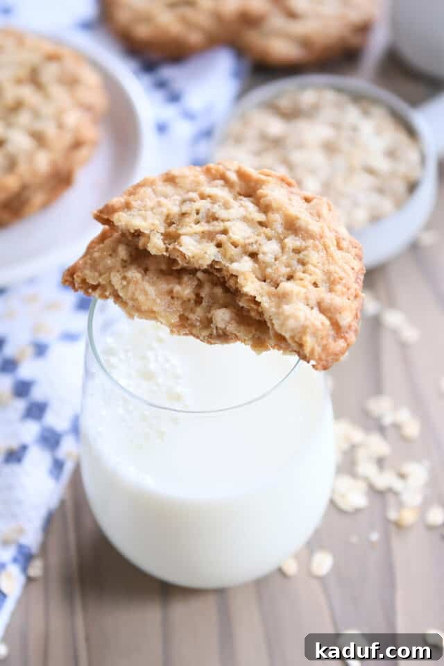 Chewy Oatmeal Lace Cookies 2 Two cookie halves sitting on top of glass of milk.