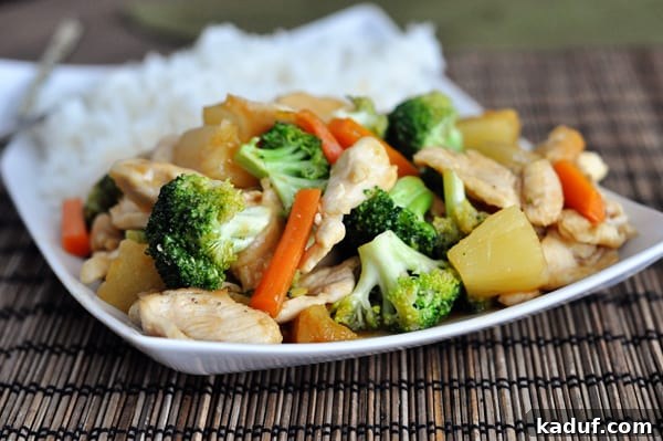 Flavorful Teriyaki Chicken Stir-Fry served alongside perfectly cooked white rice on a pristine white platter.