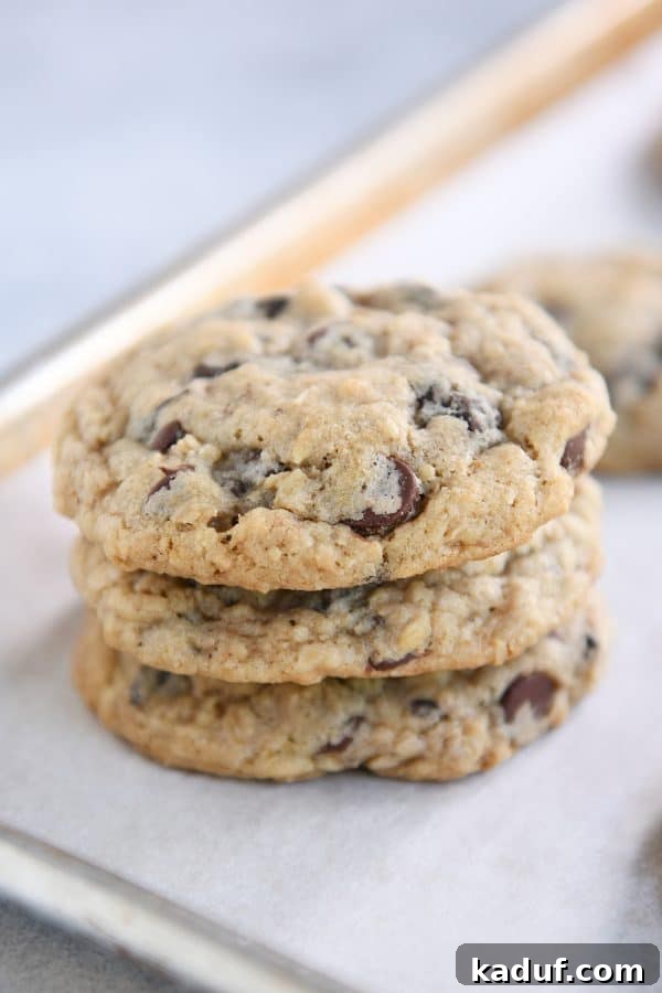 Chewy Oatmeal Chocolate Chip Cookies 3 A stack of golden-brown, chewy oatmeal chocolate chip cookies, ready to be enjoyed.