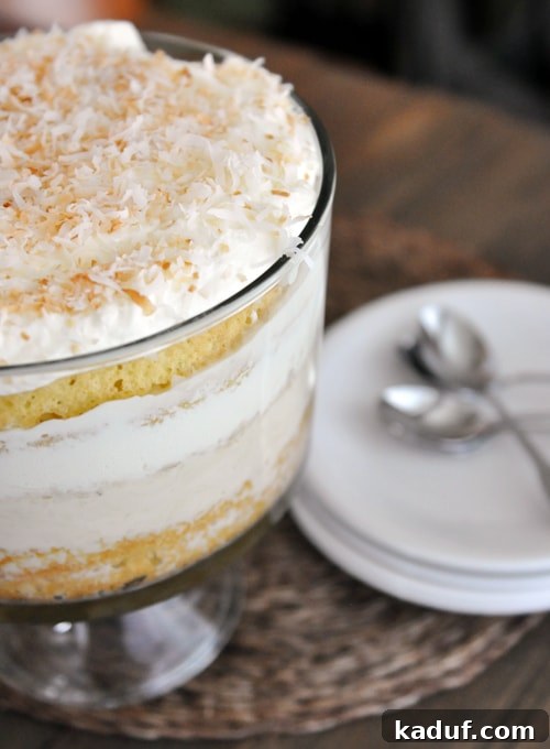 Luscious Coconut Tres Leches Trifle 2 A trifle dish full of coconut tres leches trifle topped with toasted coconut, showcasing beautiful layers.