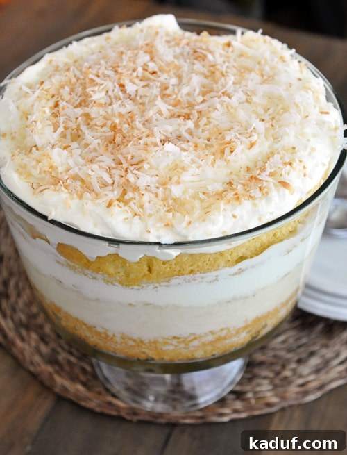 Luscious Coconut Tres Leches Trifle 4 A close-up of the rich, creamy texture and layers of the coconut tres leches cake in a trifle dish.
