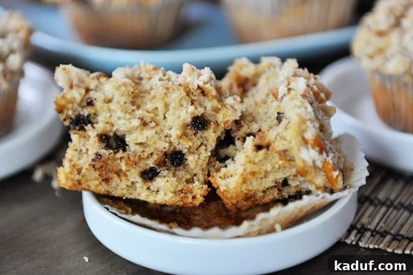 Salty Sweet Pretzel Chocolate Chip Muffins 4 A perfectly baked pretzel chocolate chip muffin, split in half to showcase its moist interior and generous distribution of chocolate chips.