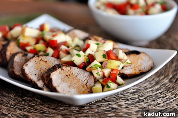 Sweet Heat Pork Tenderloin with Bright Apple Salsa 2 White platter with slices of grilled pork loin topped with fresh apple salsa.