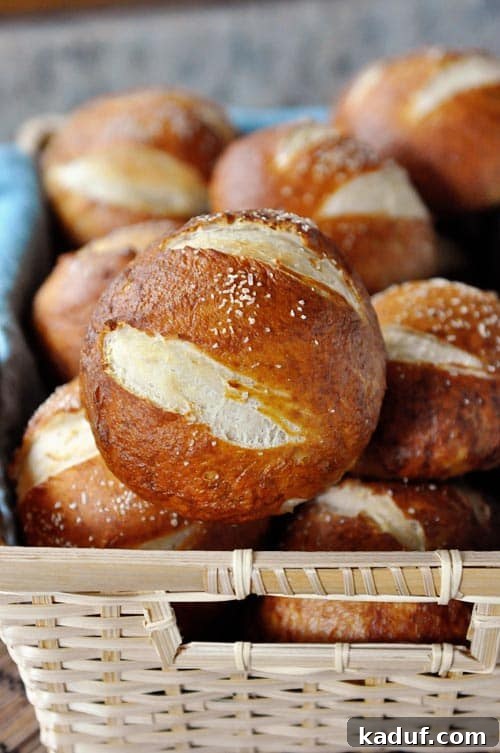 Chewy Pretzel Buns 2 A basket full of salted golden brown pretzel rolls, ready to be enjoyed.