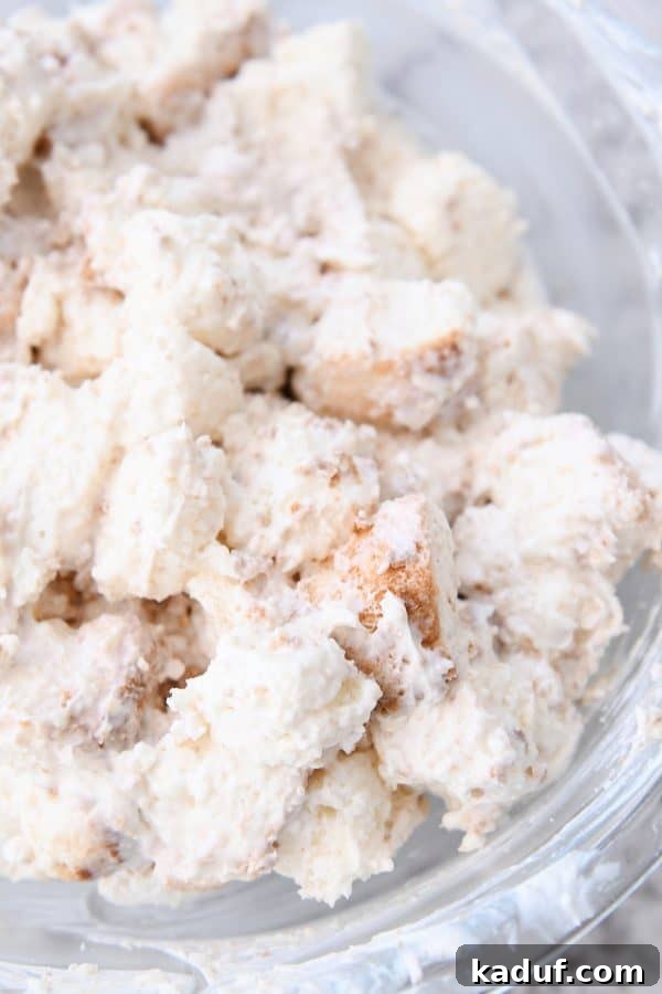Blueberry Cream Angel Cloud Cake 5 Glass bowl of cream coated angel food cake pieces.