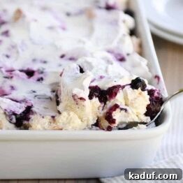Blueberry Cream Angel Cloud Cake 9 Scooping out a serving of heavenly blueberries and cream angel food cake dessert.