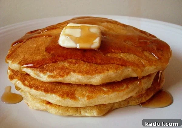 Wholesome Oat Pancake Blend 3 Pancakes in a stack with syrup and a pat of butter on top.