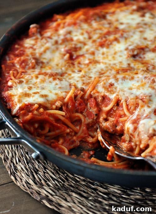 30-Minute One-Pan Baked Spaghetti 3 A cast iron skillet full of cheese-topped spaghetti.