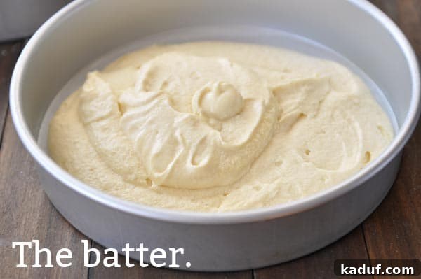 The Gold Standard Homemade Yellow Cake 11 Smooth, uncooked yellow cake batter, evenly spread in a prepared cake pan, ready for baking into a perfect homemade yellow cake.