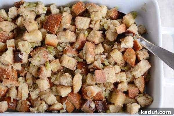 Classic Herb Thanksgiving Stuffing 4 Overhead view of a white ceramic dish generously filled with homemade Thanksgiving stuffing.