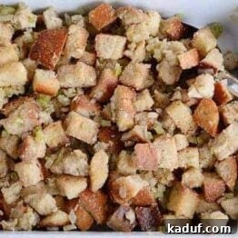 Overhead view of stuffing in a ceramic dish, perfect for a recipe card visual.
