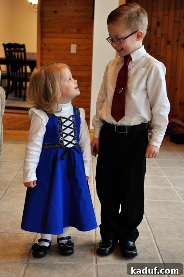 Saturday Stills 3 A sweet moment between a little boy and girl, dressed in church attire, looking at each other affectionately, highlighting sibling bond and homemade fashion.
