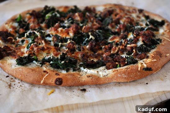 A beautifully cooked pizza with spinach and bacon, featuring a golden brown, crispy whole wheat crust, served on parchment paper.