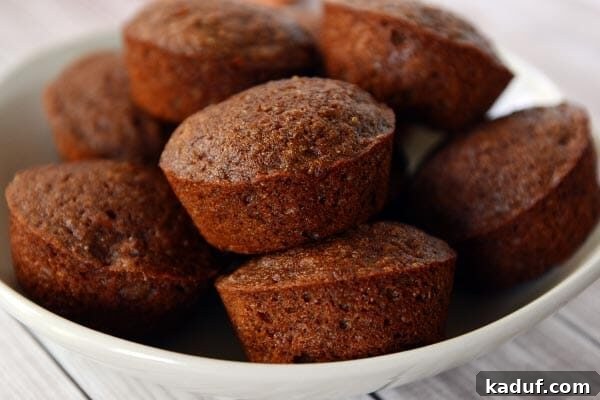 Morning Superfood Power Muffins 3 A white plate full of golden brown cooked Good Morning Power Muffins, ready to be served.