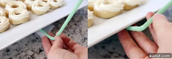A green bendy straw being carefully taped to the underside edge of a white ceramic platter filled with frosted sugar cookies.