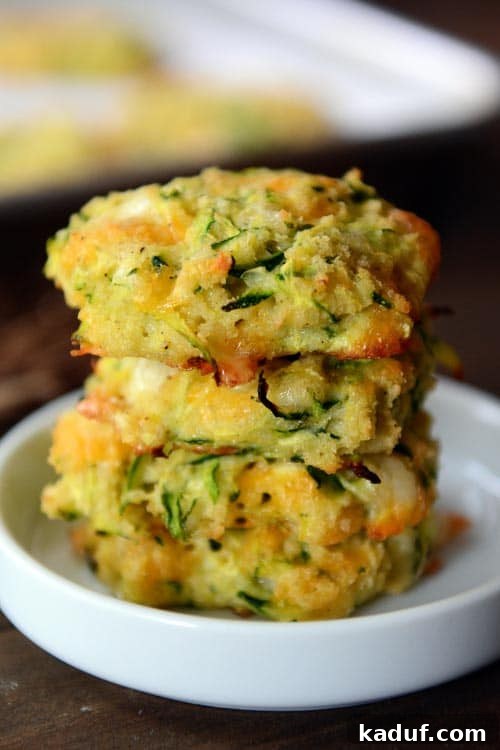 Cheesy Zucchini Gems 8 Four Baked Cheesy Zucchini Bites stacked on a small white ramekin.