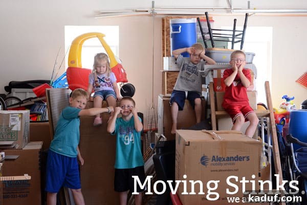 Saturday's Moving Moments 2 Five excited children making silly faces, surrounded by moving boxes, signifying a family move.