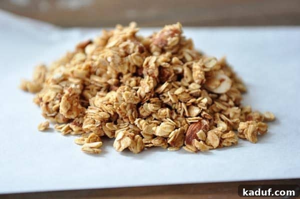 Golden Peanut Butter Clusters 3 Peanut butter granola in a little pile on a piece of parchment.