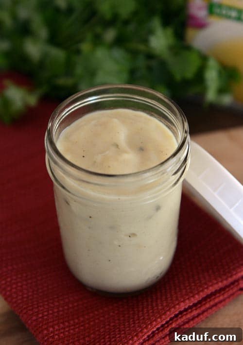 A glass mason jar full of homemade cream of chicken soup. Healthy alternative to canned soup.