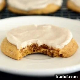 Soft Batch Iced Pumpkin Sugar Cookies, showing their perfect texture and delicious frosting.