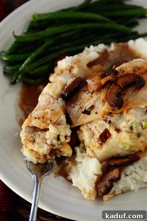 Olive Garden-Style Stuffed Chicken Marsala 2 Golden-brown stuffed chicken breast on a bed of creamy mashed potatoes, served alongside vibrant green beans, inviting a gourmet dining experience at home.
