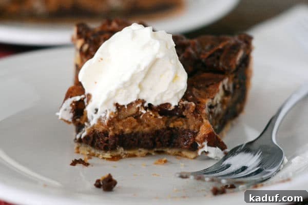 Decadent Chocolate Caramel Pecan Bliss 3 A close-up shot of a slice of chocolate caramel pecan pie with a perfect bite taken out, revealing its rich layers.