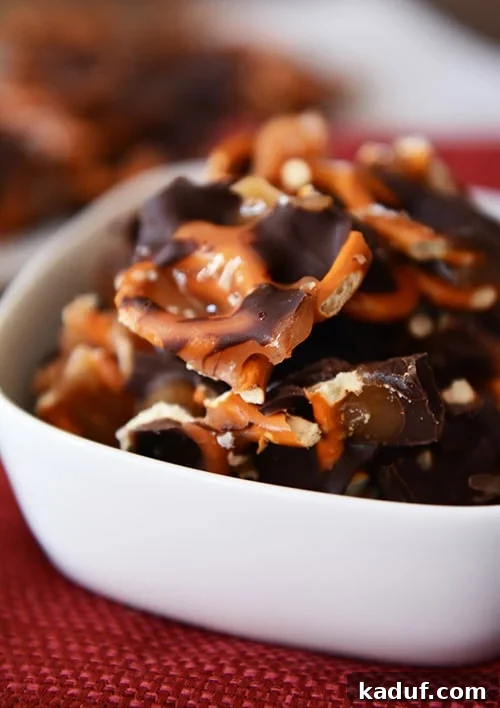 Sweet and Salty Dark Chocolate Caramel Pretzel Bark 2 A white bowl full of homemade dark chocolate sea salt caramel pretzel bark, ready to be enjoyed or shared.