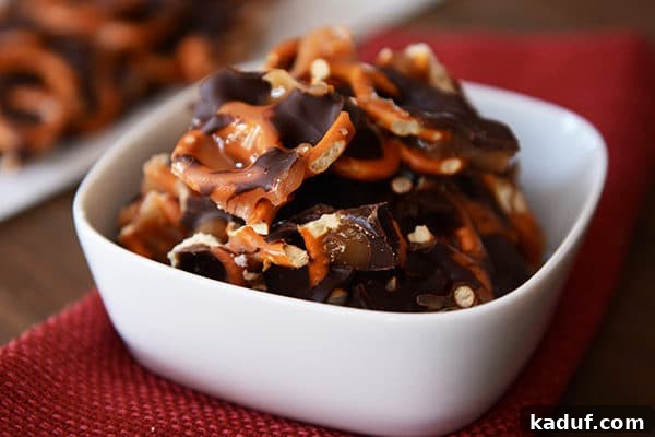 Sweet and Salty Dark Chocolate Caramel Pretzel Bark 4 A white ramekin filled with irresistible chunks of dark chocolate sea salt caramel pretzel bark.