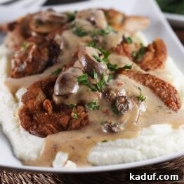 Smothered Crispy Pork Cutlets with Cauliflower Mash ready to serve