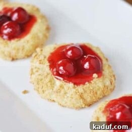 Velvet Cherry Cheesecake Cookies 4 Close-up of a Cherry Cheesecake Cookie showing the rich filling and crumbly exterior.