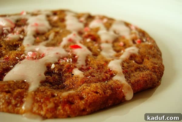 Minty Molasses Cookies 3 Close up of a peppermint glazed cookie with crushed peppermint candies on top, showing its soft texture