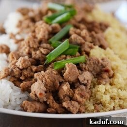 20-Minute Korean Beef and Rice or Quinoa Meal 5 A scoop of Korean beef and rice, garnished with green onions, ready to be served.