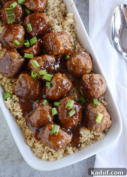 Sweet & Sticky Skillet Teriyaki Meatballs 2 Top view of a white casserole dish full of rice topped with glistening teriyaki coated meatballs, ready to serve.