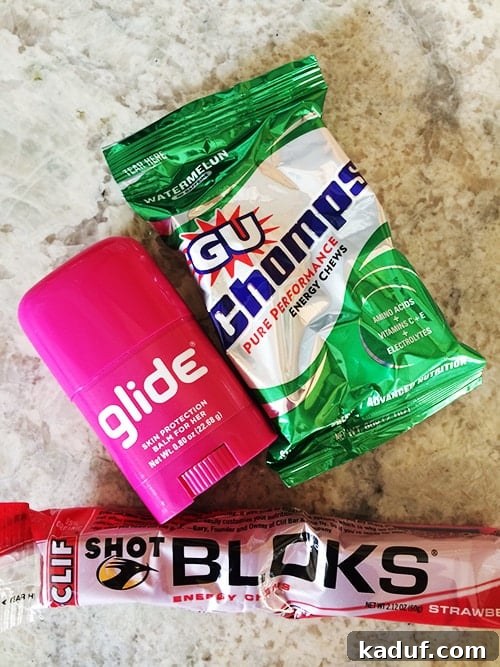Weekly Training Recap 12 3 A collection of essential running gear: energy chews, a water bottle, and anti-chafing balm, ready for a long run.