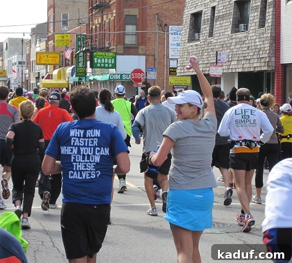 Her Name Was Jessica 3 A large group of runners, including a woman with her arm raised and a man in a blue shirt, enthusiastically running during a marathon.