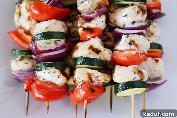 Juicy Greek Chicken Skewers with Refreshing Tzatziki 3 Top view of a stack of Greek chicken and vegetable kebabs.