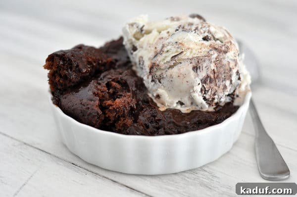 Molten Fudge Pudding Dream 2 White ramekin with chocolate pudding cake and a scoop of ice cream on top.