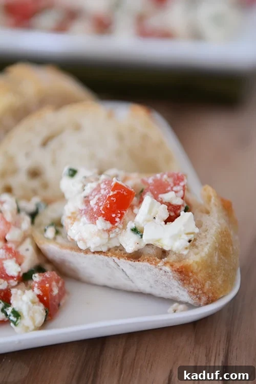 Effortless Greek Feta Perfection 3 A sliced baguette topped with a Greek feta dip.
