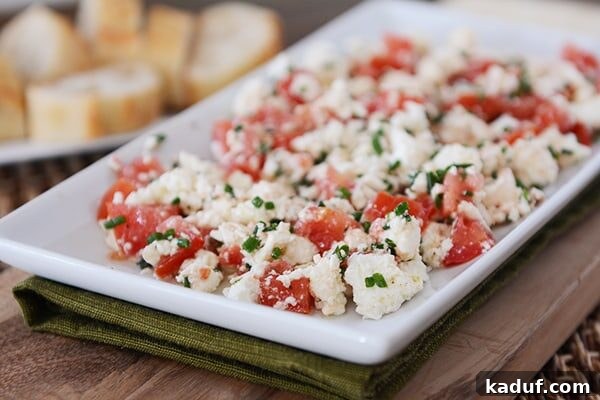 Effortless Greek Feta Perfection 4 White tray full of a Greek feta tomato dip.