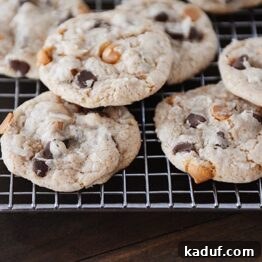 Soft Chewy Seven Layer Cookies Individual Perfection 6 Freshly baked 7-layer cookies cooling on a wire rack, featuring chocolate and butterscotch chips.