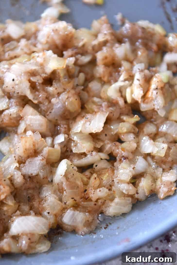 Rustic German Potato Salad 4 A skillet full of sautéed onions, translucent and glistening from cooking in bacon drippings.