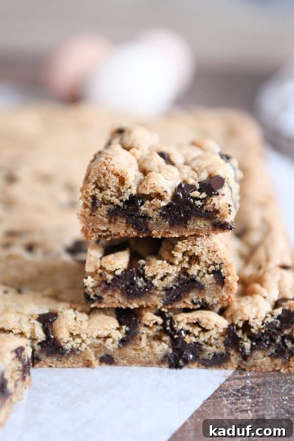 Decadent Thick and Chewy Chocolate Chip Cookie Bars 4 Another enticing shot of two stacked chocolate chip cookie bars, emphasizing their generous height and perfectly baked edges.