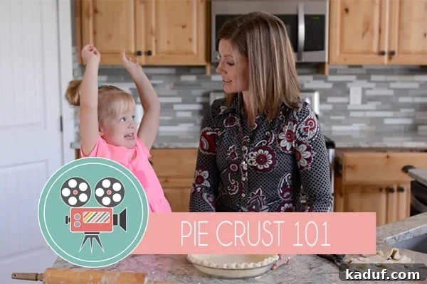 The Ultimate Secret to Flaky Pie Crust 2 A mom and little girl cooking in the kitchen together, creating a beautiful pie crust.