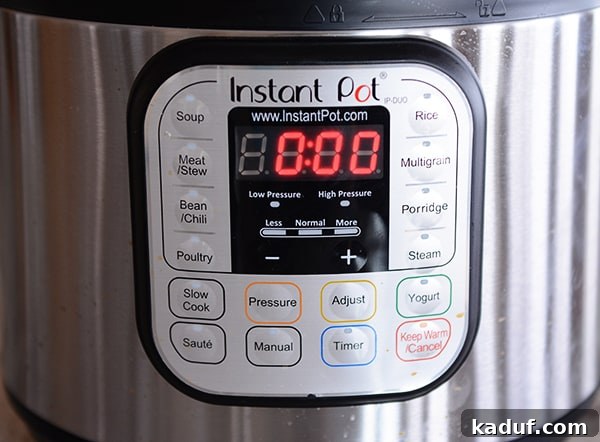 Exploring Pressure Cooking Benefits Types and Resources 9 The digital control panel of an Instant Pot electric pressure cooker, displaying various cooking functions and settings.
