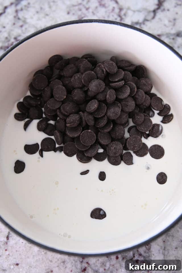 Decadent Chocolate Fondue 3 Chocolate chips and cream melting together in a fondue pot, illustrating the first step.