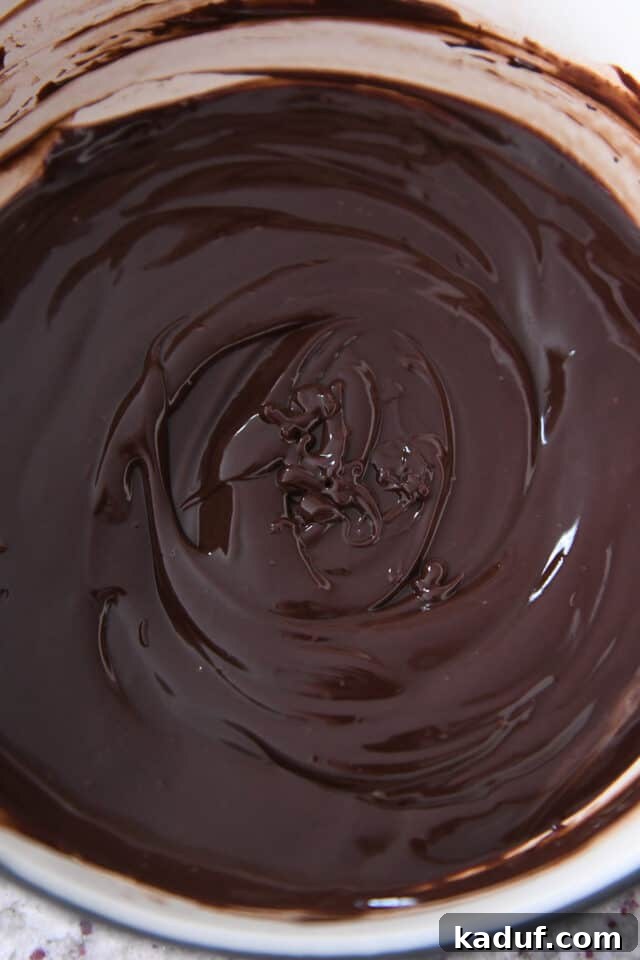 Decadent Chocolate Fondue 4 Creamy chocolate fondue glistening in a fondue pot, showcasing its perfect texture.