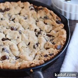Irresistible Egg-Free Skillet Chocolate Chip Cookie 4 A soft baked skillet cookie with chocolate chips, ready to be served.