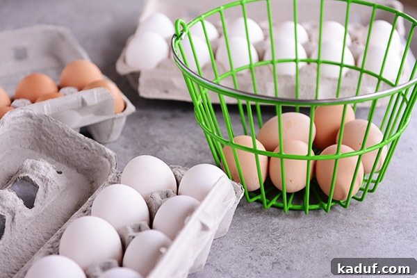 Why Egg Size Isn't Just a Number 4 A selection of raw eggs in various cartons and a green basket, ready for classification and measurement.