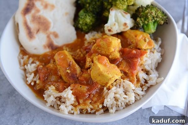 Chicken Curry with Rice, Veggies, and Flatbread Top view of a bowl full or rice topped with chicken curry, veggies, and flatbread.